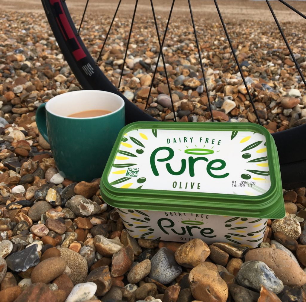 Pure on a pebbly beach with tea and a bike wheel